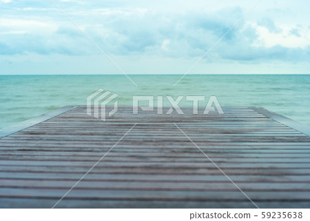 Selective focus on wooden table surface with blue cloudy sky in background 59235638