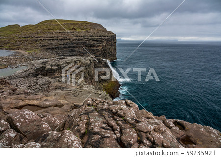 Bosdalafossur waterfall to the ocean on Faroe Islands coastline Bosdalafossur waterfall to the ocean on Faroe Islands coastline 59235921