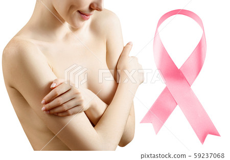 Young woman covers her breast near big pink ribbon. 59237068