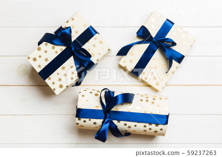 Beautiful gift box with a colored bow on the white 59237263