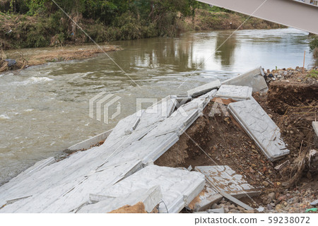 Typhoon damage river flooding embankment collapse 59238072