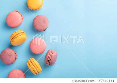 Colorful French or Italian macaron stack on blue table with copy space for background 59240154