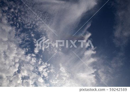 Slightly, the ring zenith arc, upside down rainbow. blue sky. The sun is in the lower right. Background material. Slightly, the ring zenith arc, upside down rainbow. blue sky. The sun is in the lower right. Background material. 59242589
