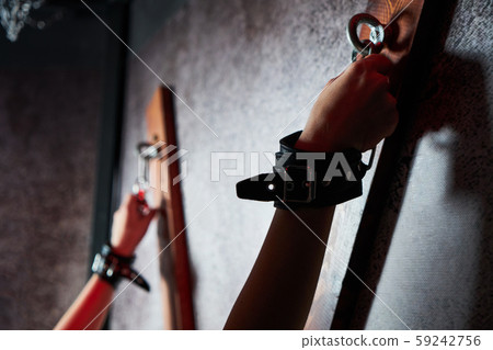 Sexy woman in handcuffs. Games for adults in the room BDSM. 59242756