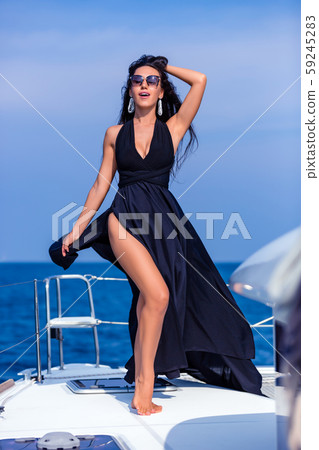 Young happy woman in black dress enjoying evening 59245283