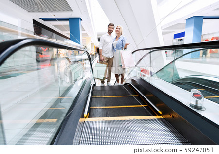 Couple Walking Up Escalator Shopping In Hypermarket 59247051