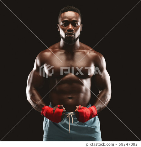 Portrait of handsome athletic boxing fighter with his hands wrapped Portrait of handsome athletic boxing fighter with his hands wrapped 59247092