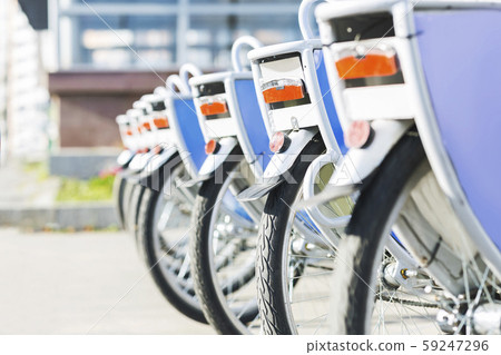 Bicycles for rent in city, close up of wheels outdoor Bicycles for rent in city, close up of wheels outdoor 59247296