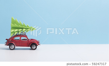 Red toy car with pine tree on the top on background Red toy car with pine tree on the top on background 59247317