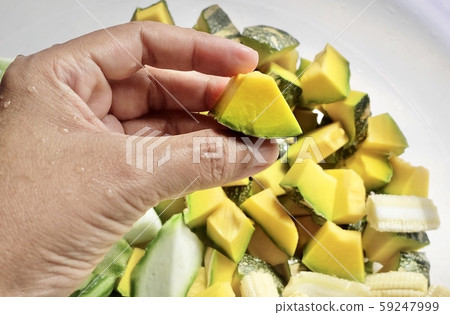 Hand Holding Chopped Pumpkins with Sponge Gourds Hand Holding Chopped Pumpkins with Sponge Gourds 59247999