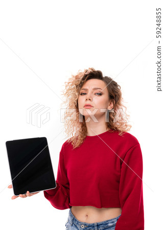 Caucasian girl with curly fair hair holds a tablet , portrait isolated on white background Caucasian girl with curly fair hair holds a tablet , portrait isolated on white background 59248855
