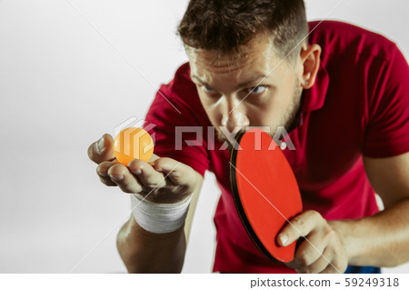 Young man playing table tennis on white studio background 59249318