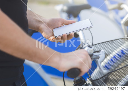 Man using GPS navigator in his phone cycling in city 59249497