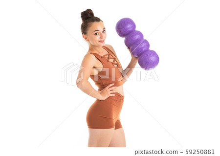 A beautiful young female gymnast stands with sporting inventory A beautiful young female gymnast stands with sporting inventory 59250881