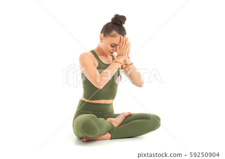 Young caucasian gymnast with athletic body sits on a floor in lotus position, doing yoga and Young caucasian gymnast with athletic body sits on a floor in lotus position, doing yoga and 59250904