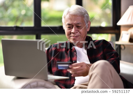 Happy Asian senior man using credit card for online shopping 59251137