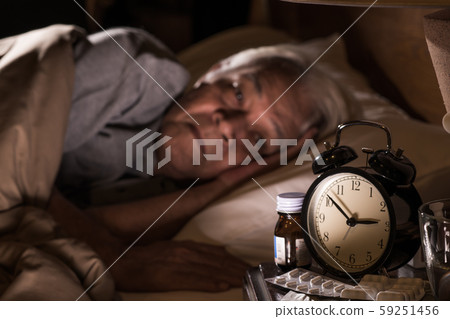 Depressed senior man lying in bed cannot sleep from insomnia Depressed senior man lying in bed cannot sleep from insomnia 59251456