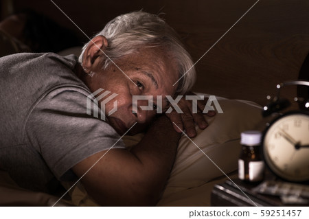 Depressed senior man lying in bed cannot sleep from insomnia Depressed senior man lying in bed cannot sleep from insomnia 59251457