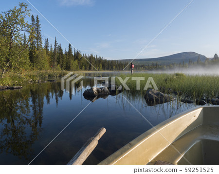 View from rowing boat on Fisherman man at lake 59251525