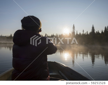 Fisherman man in rowing boat at lake Fisherman man in rowing boat at lake 59251528