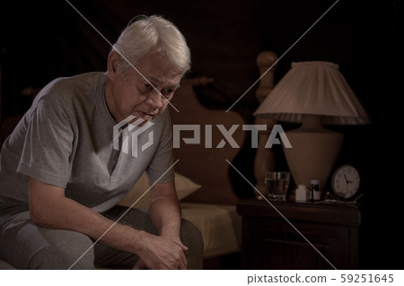 Depressed senior person sitting in bed cannot sleep from insomnia Depressed senior person sitting in bed cannot sleep from insomnia 59251645