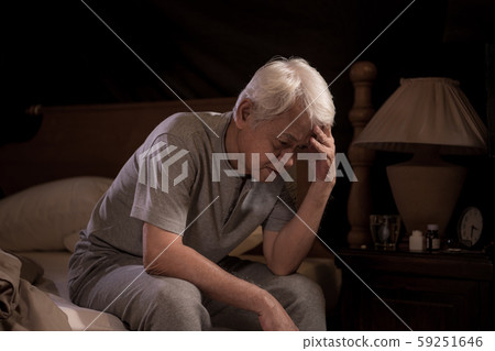 Depressed senior person sitting in bed cannot sleep from insomnia 59251646