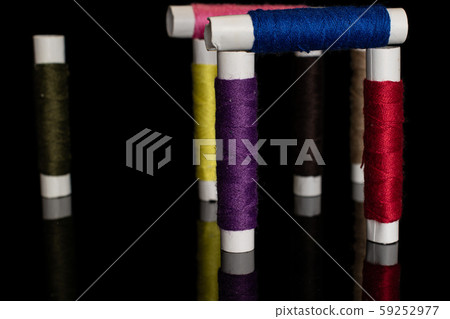 Sewing thread spool isolated on black glass Sewing thread spool isolated on black glass 59252977