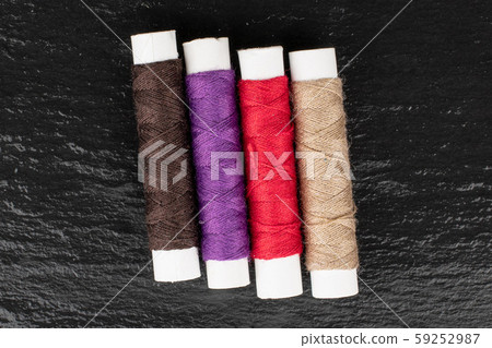 Sewing thread spool on grey stone Sewing thread spool on grey stone 59252987