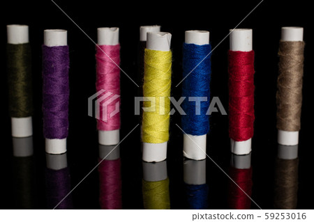 Sewing thread spool isolated on black glass 59253016