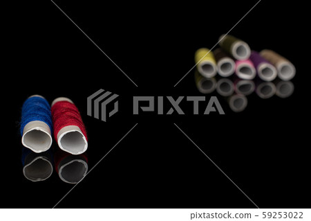 Sewing thread spool isolated on black glass 59253022