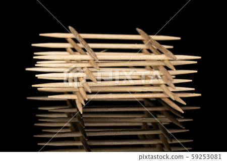 Wooden brown toothpick isolated on black glass Wooden brown toothpick isolated on black glass 59253081