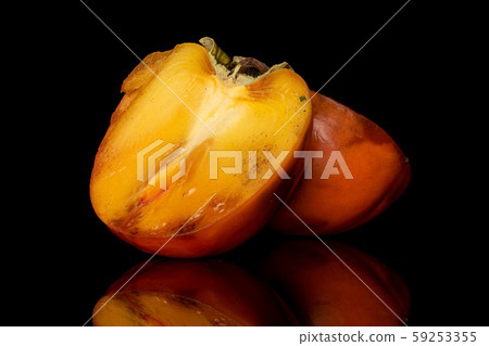Sweet orange persimmon isolated on black glass 59253355