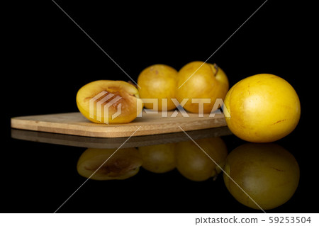 Fresh yellow plum isolated on black glass 59253504