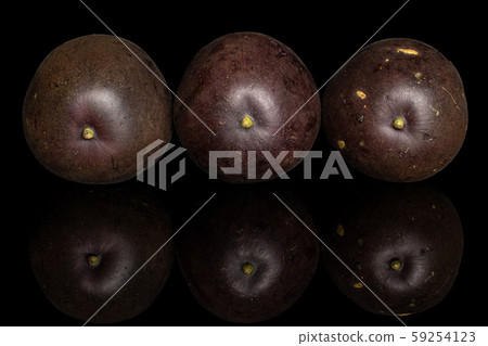 Sweet dark passion fruit isolated on black glass 59254123