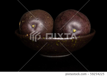 Sweet dark passion fruit isolated on black glass Sweet dark passion fruit isolated on black glass 59254225