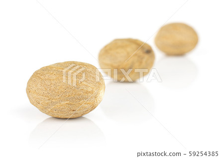 Dry brown nutmeg isolated on white Dry brown nutmeg isolated on white 59254385
