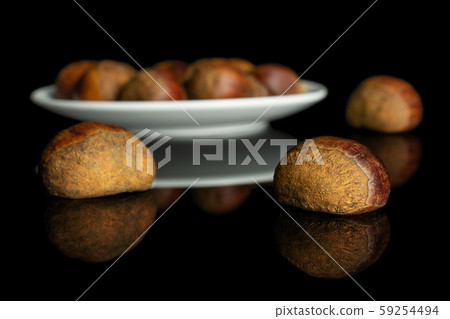 Sweet brown chestnut isolated on black glass 59254494
