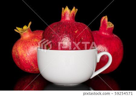 Fresh red pomergranate isolated on black glass Fresh red pomergranate isolated on black glass 59254571