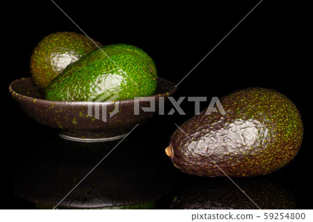 Fresh green avocado isolated on black glass Fresh green avocado isolated on black glass 59254800