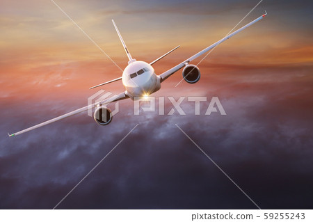 Commercial airplane flying above dramatic clouds. Commercial airplane flying above dramatic clouds. 59255243