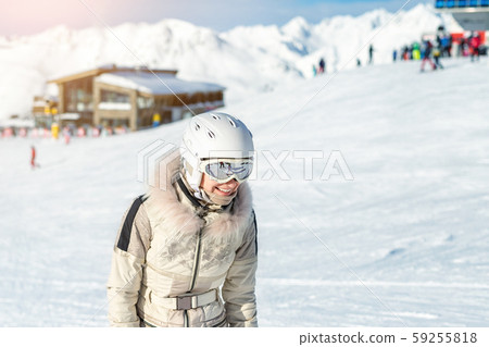 Portrait of young adult beautiful happy caucasian woman smiling near lift station at alpine winter Portrait of young adult beautiful happy caucasian woman smiling near lift station at alpine winter 59255818