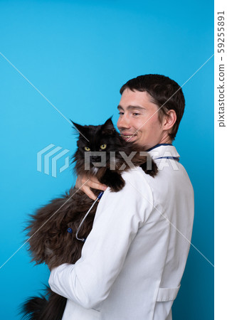 Brunet vet with black cat in his arms Brunet vet with black cat in his arms 59255891