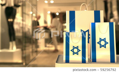 Flag of Israel on the paper shopping bags against blurred store entrance. Retail related 3D Flag of Israel on the paper shopping bags against blurred store entrance. Retail related 3D 59256792