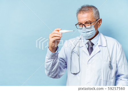 Portrait of a handsome senior doctor holding a thermometer in his hands, on a thermometer, the 59257560