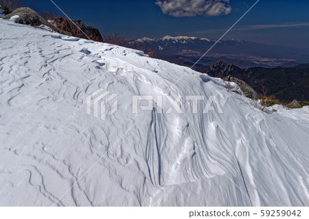 A view of the snow crest and Yatsugatake mountain range on the Mt. A view of the snow crest and Yatsugatake mountain range on the Mt. 59259042