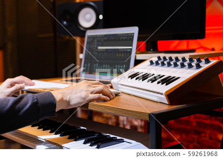 male composer, producer, arranger, song writer, musician hands arranging music on computer in home studio. music production concept male composer, producer, arranger, song writer, musician hands arranging music on computer in home studio. music production concept 59261968