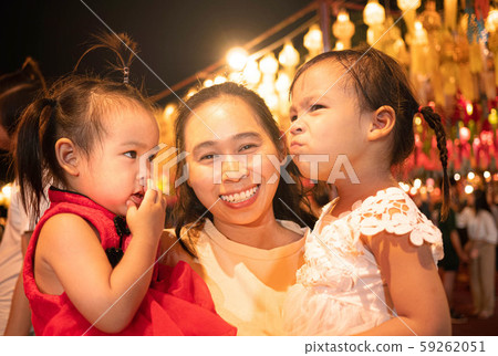 Happy Asian family standing over light from Thai 59262051