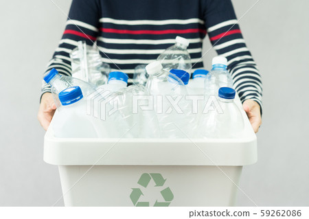 A woman hold a sorted recycle bin full of single-use plastic beverage bottles and other plastic waste. Waste segregation, Single-use plastic problems, Environmental awareness, Plastic Recycle concept. A woman hold a sorted recycle bin full of single-use plastic beverage bottles and other plastic waste. Waste segregation, Single-use plastic problems, Environmental awareness, Plastic Recycle concept. 59262086