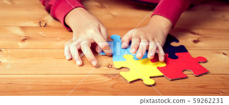 Banner picture of an autistic child's hands playing a puzzle symbol of Public awareness for autism spectrum disorder. World Autism Awareness day April 2, Supportive, Understanding and Acceptance. Banner picture of an autistic child's hands playing a puzzle symbol of Public awareness for autism spectrum disorder. World Autism Awareness day April 2, Supportive, Understanding and Acceptance. 59262231