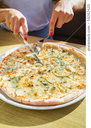woman eating pizza in the cafe woman eating pizza in the cafe 59262420
